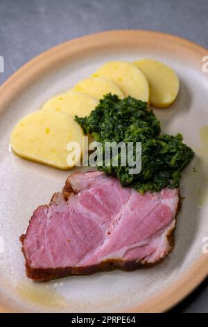 smoked meat with spinach and potato dumplings Stock Photo