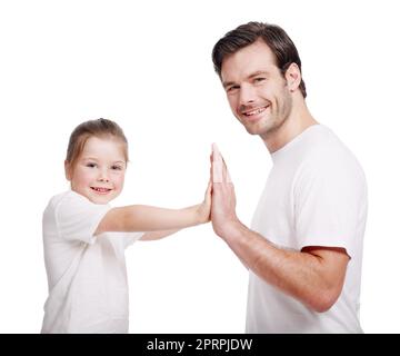 Dad and daughter fun. Portrait of a young father and his little girl being playful. Stock Photo