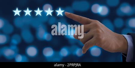 Hand of businessman touching five stars symbol to increase rating on background Stock Photo