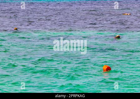 Blue turquoise water waves ocean with buoy and ropes Mexico. Stock Photo