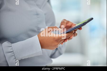Phone, hands and communication with a business woman networking with wifi technology in her office at work. Closeup of a female employee reading, typing or sending a text message on her mobile Stock Photo