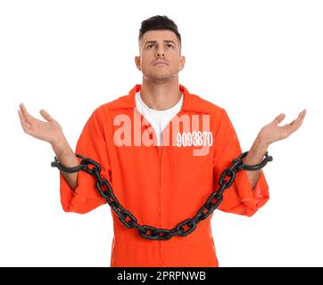 Prisoner in orange jumpsuit with chained hands on white background Stock Photo