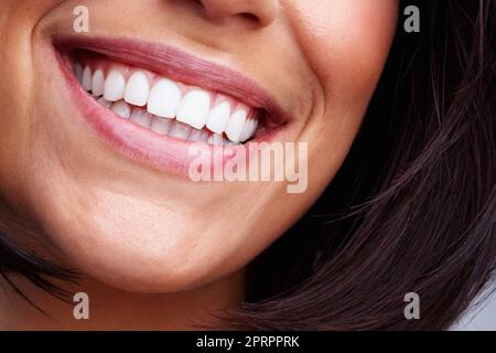Detail shot of a pretty young female smiling. Detail shot of a pretty young woman smiling. Stock Photo