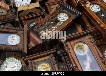 Group of vintage wooden wall clocks lying Stock Photo