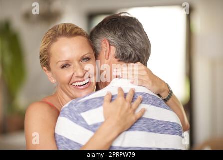 Proud wife of an amazing husband. Portrait of a beautiful woman embracing her husband. Stock Photo