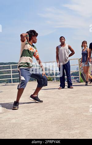 Dancing in the streets. a group of young people watching a breakdancer in the streets. Stock Photo