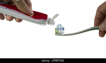 a man puts toothpaste on a toothbrush on a transparent background Stock Photo