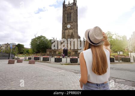 Tourism in UK. Back view of beautiful woman visiting in the city of Manchester, United Kingdom. Stock Photo