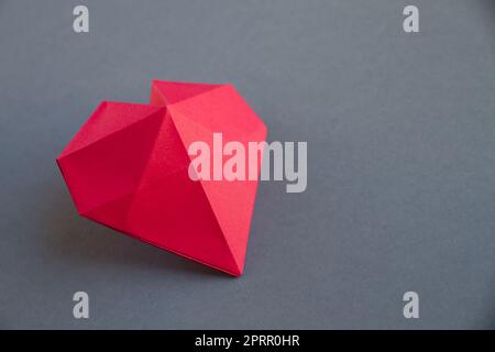 Red paper heart origami isolated on a grey background Stock Photo