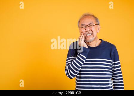 Portrait senior old man sad hand touching cheek suffering from toothache Stock Photo