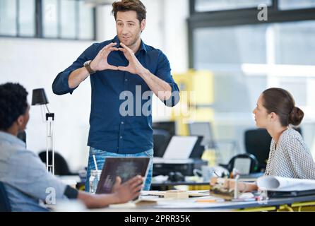 Creating workplace synergy. a group of young designers working together in an office. Stock Photo