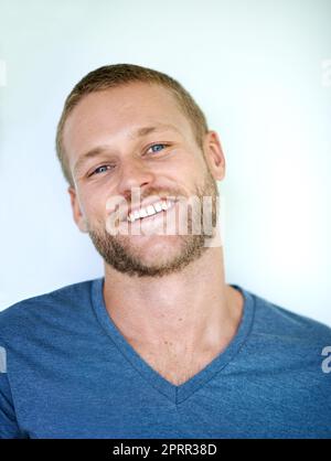 Happiness is handsome. Studio shot of a handsome young man posing against a white background. Stock Photo