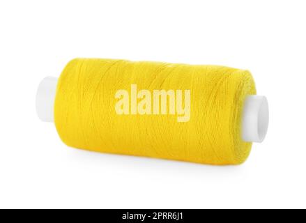 Spool of yellow sewing thread isolated on white Stock Photo