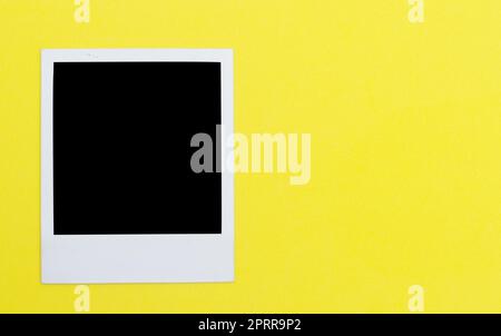 Polaroid photo frame on yellow background Stock Photo