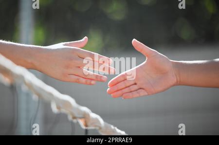 Tennis, shaking hands and sports court competition, challenge and welcome to start outdoor team games. Badminton training, handshake and collaboration Stock Photo