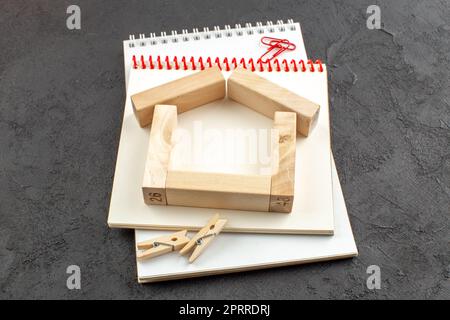bottom view spiral notebooks wood blocks on black background Stock Photo