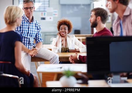 Its an easygoing work environment. a group of designers in their modern office. Stock Photo