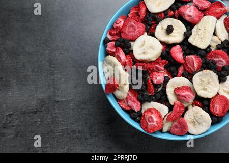 Bowl of dried fruits on grey table, top view. Space for text Stock Photo