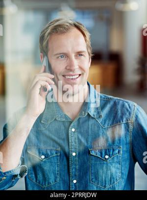 Hes a model employee. a casually-dressed businessman standing in his office. Stock Photo
