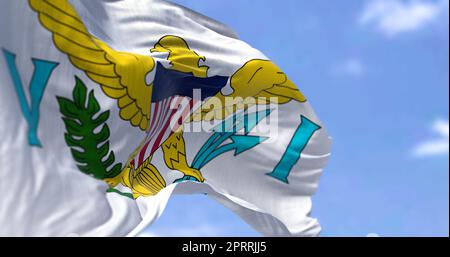 Flags of United States Virgin Islands waving in the wind with the US flag on a clear day Stock Photo