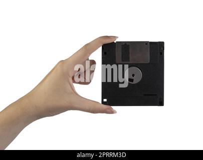 an old floppy disk in the female hand on a transparent background Stock Photo