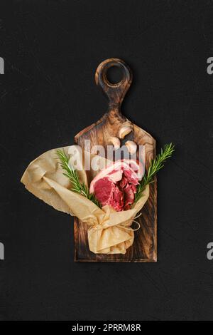 Raw lamb double loin chop wrapped in paper Stock Photo