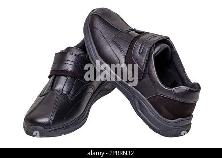 Mans black shoes. Close-up of a pair of black sneakers or sport shoes isolated on a white background. Clipping path. Elegant and trendy mens footwear. Macro. Stock Photo