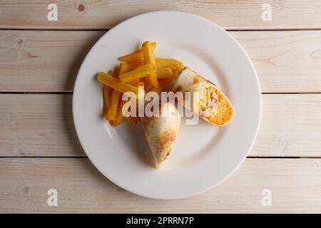 Meat, spicy carrot, cabbage and cheese rolled up in pitta bread Stock Photo