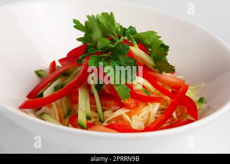 Closeup view of spring salad with paprika, cucumber and cabbage. Stock Photo