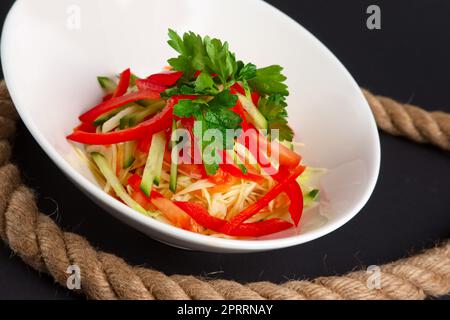 Spring salad with paprika, cucumber and cabbage. Stock Photo