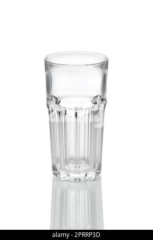 Empty transparent faceted glass with reflection on white background. Stock Photo