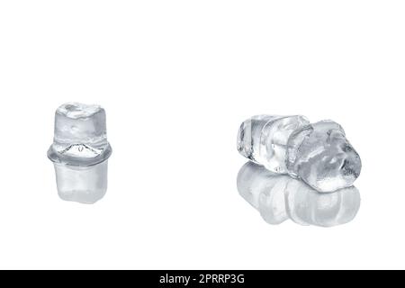 Piece of ice cubes melting on white glass table Stock Photo