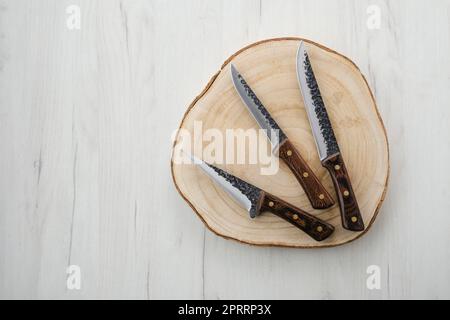 https://l450v.alamy.com/450v/2prrp3x/forged-butchers-knives-on-wooden-stump-2prrp3x.jpg