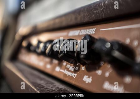 Electric guitar amplifier device leather-covered. Closeup Stock Photo