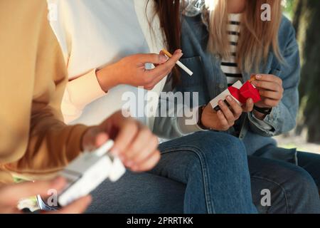 Man taking cigarette out of pack outdoors, closeup Stock Photo