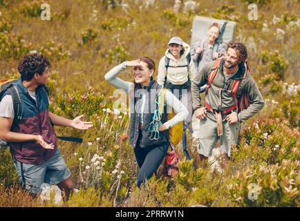 Group hiking, nature travel and guide in communication with friends on holiday in countryside of Peru, freedom on walk for fitness and happy on vacation. People talking while climbing mountain Stock Photo