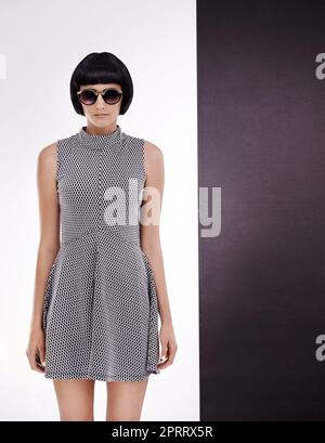 Simply stylish. Studio shot of a retro-stylish young woman against a black and white background. Stock Photo