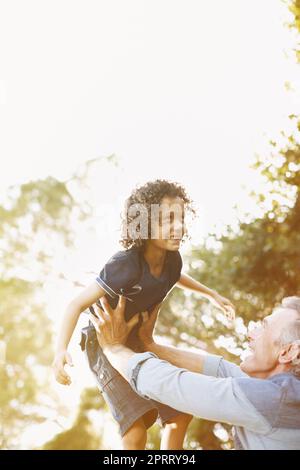 Theres my boy. A grandfather playing with his grandson in the park. Stock Photo
