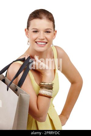 That sale was awesome. Closeup shot of a pretty teenage girl carrying a shopping bag over her shoulder. Stock Photo