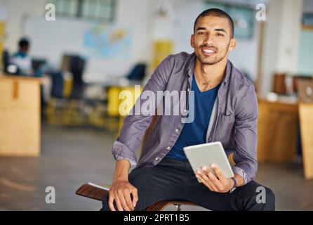 We tailor to your mobile lifestyle. Portrait of a handsome young man using a digital tablet in an office. Stock Photo