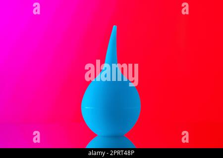 front view bulb syringe aspirator on light red background Stock Photo