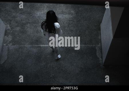 Back woman ghost horror under building house, halloween concept Stock Photo