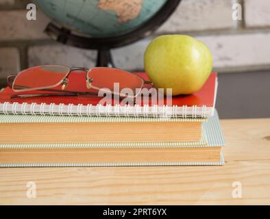 World teachers ' Day in school. Still life with books, globe, Apple glasses Stock Photo