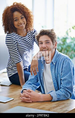 Friends and colleagues. two colleagues working in their office. Stock Photo