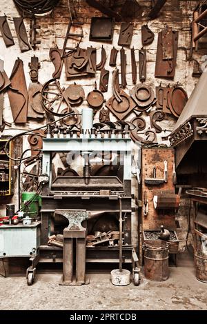 An artists tools. a metal craftsmans workshop filled with tools. Stock Photo