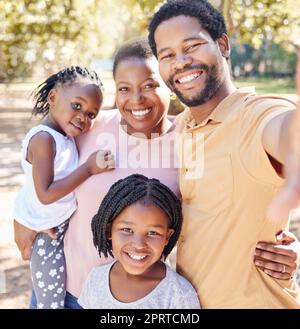 Happy black family take a selfie in nature on a holiday vacation trip together enjoy quality time at a kids park. Smile, happiness and African girls love taking pictures with their mother and father Stock Photo