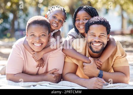 Portrait of relax black family in picnic nature park enjoy quality time, outdoor peace or freedom while bonding together. Love, hug and happy kids or children smile on spring holiday with mom and dad Stock Photo