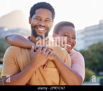 Portrait, happy and couple smile with hug while in the city on a date in summer. African american man and woman bonding together with joy, love and happiness in a healthy relationship or marriage Stock Photo