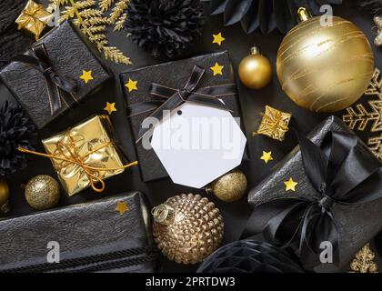 Black and golden Christmas Gift Boxes and ornaments, square gift tag Mockup Stock Photo