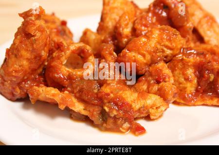 Fried Pork Skins With Red Salsa in Rustic Kitchen Stock Photo